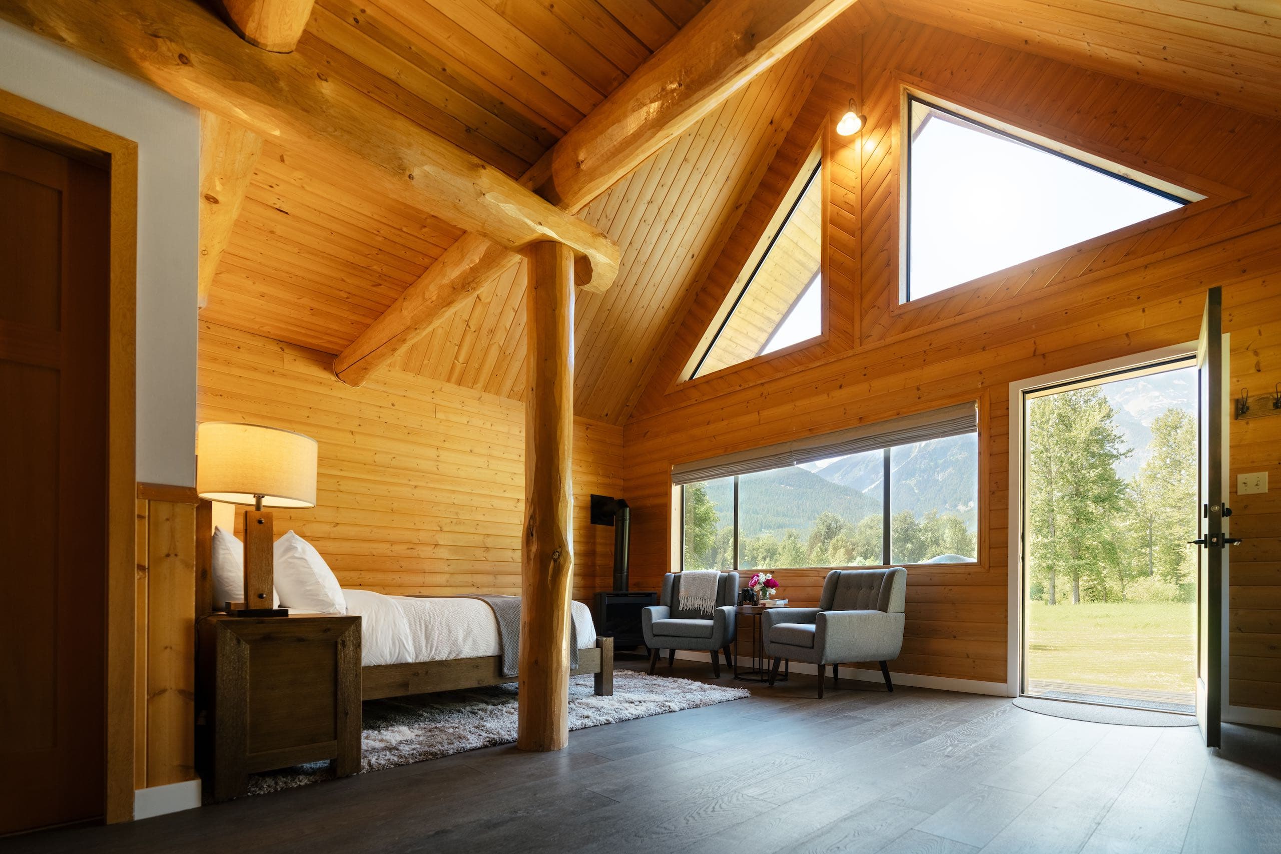 Wood paneled room with large window and open doorway