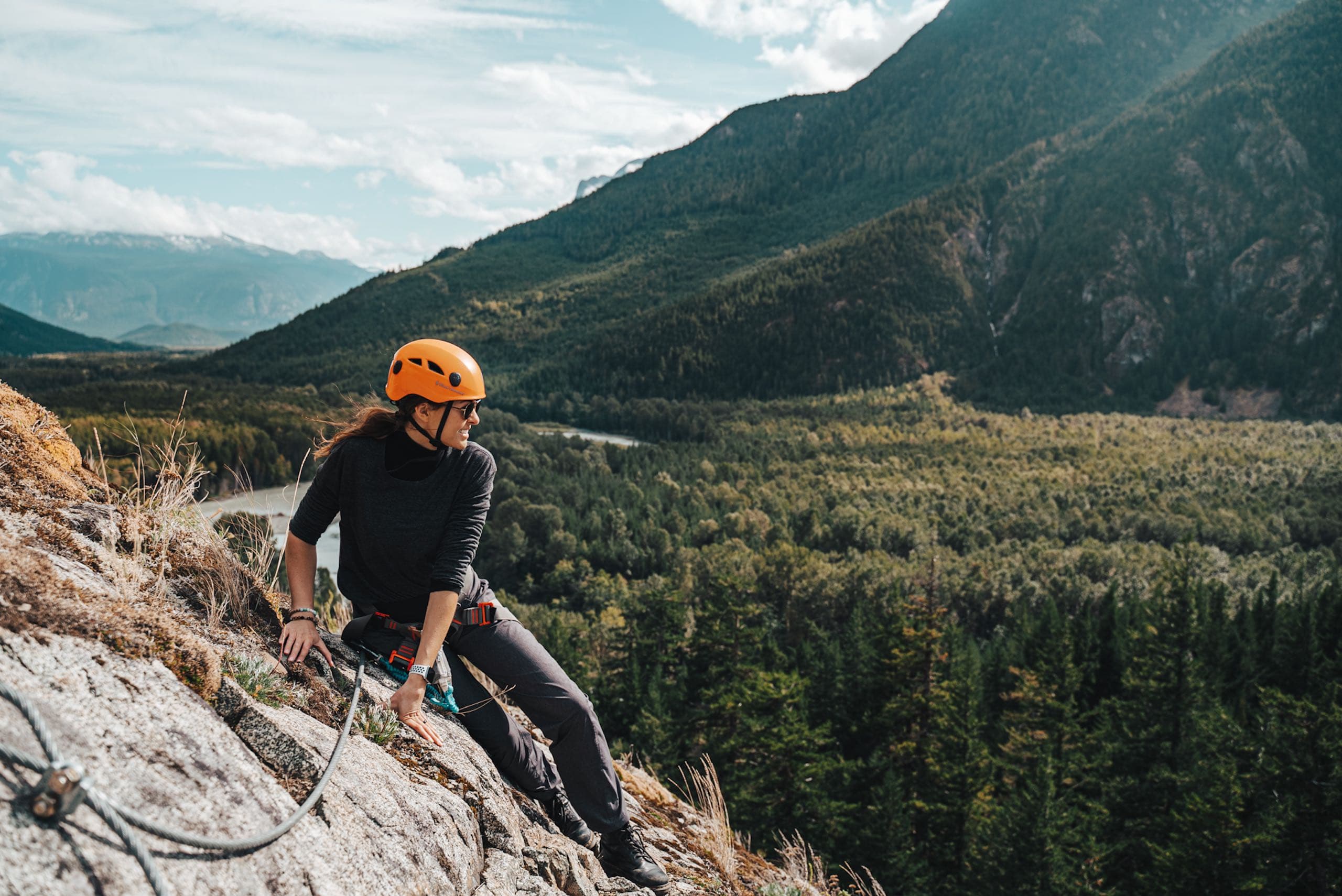 A woman taking in the view mid-climb