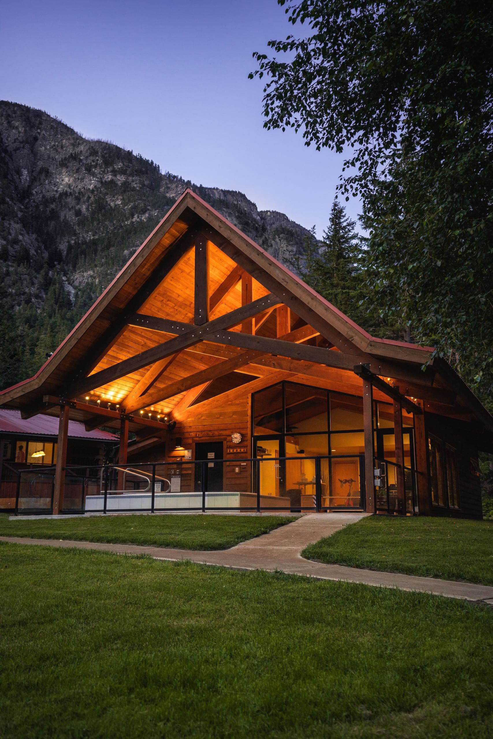 A large cabin like structure that has a hot tub and gym