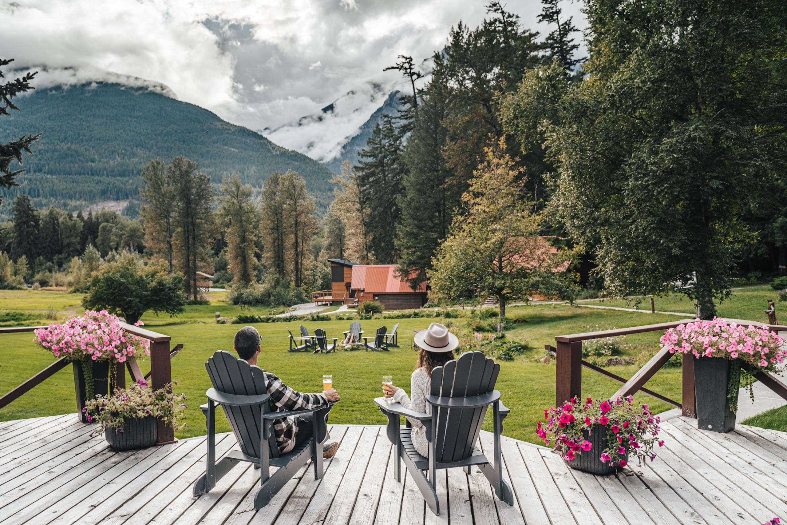 A couple sitting on their porch drinking beer