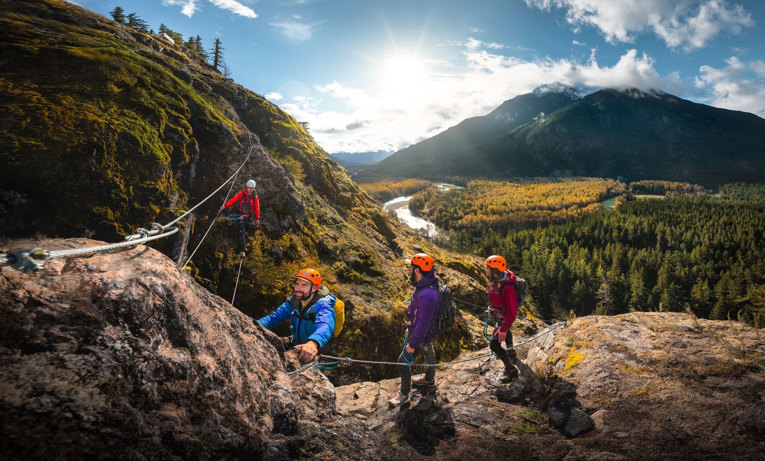 A group of people climbing a mountain with ropes