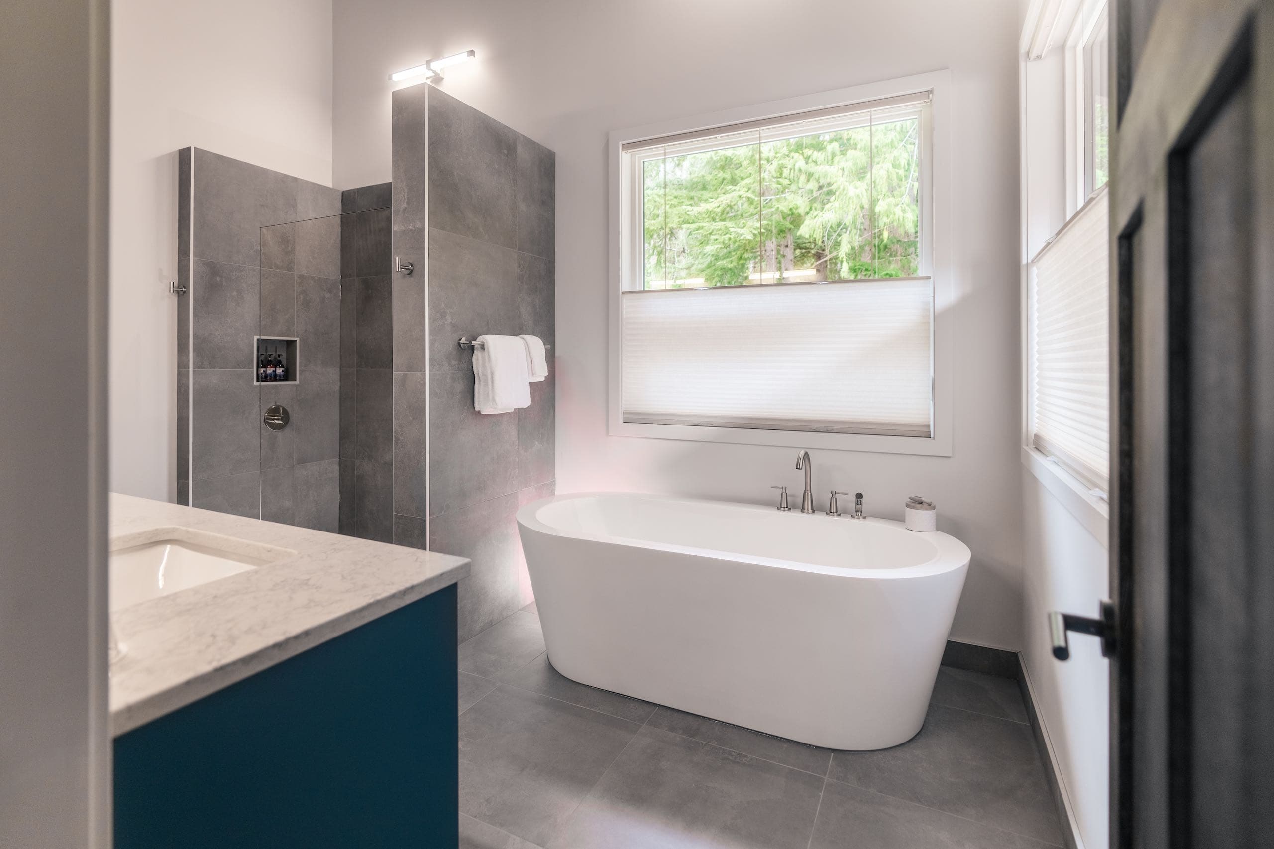 A Bathroom with a walk in shower and tub