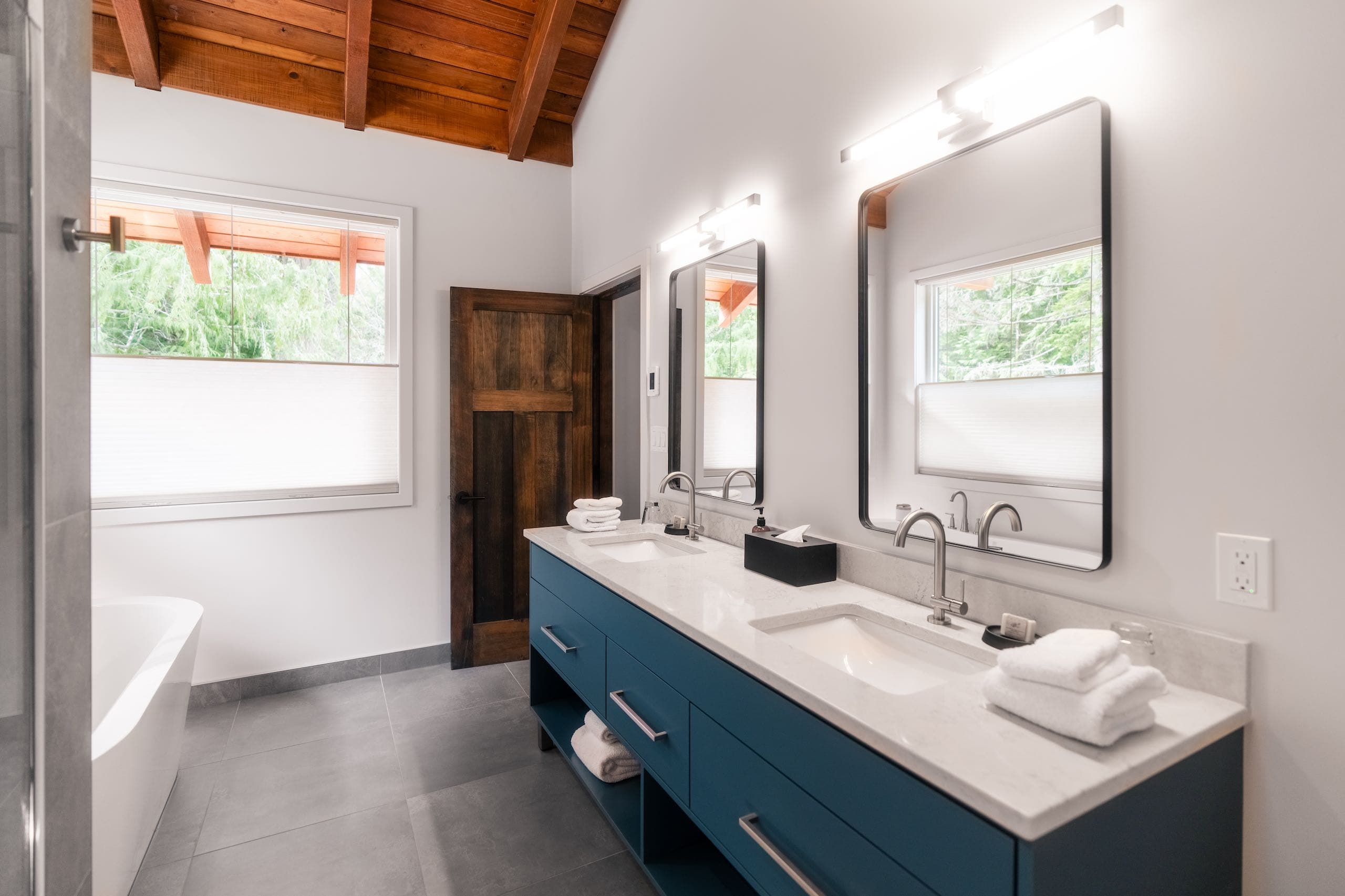Bathroom with blue cupboards and a double sink vanity