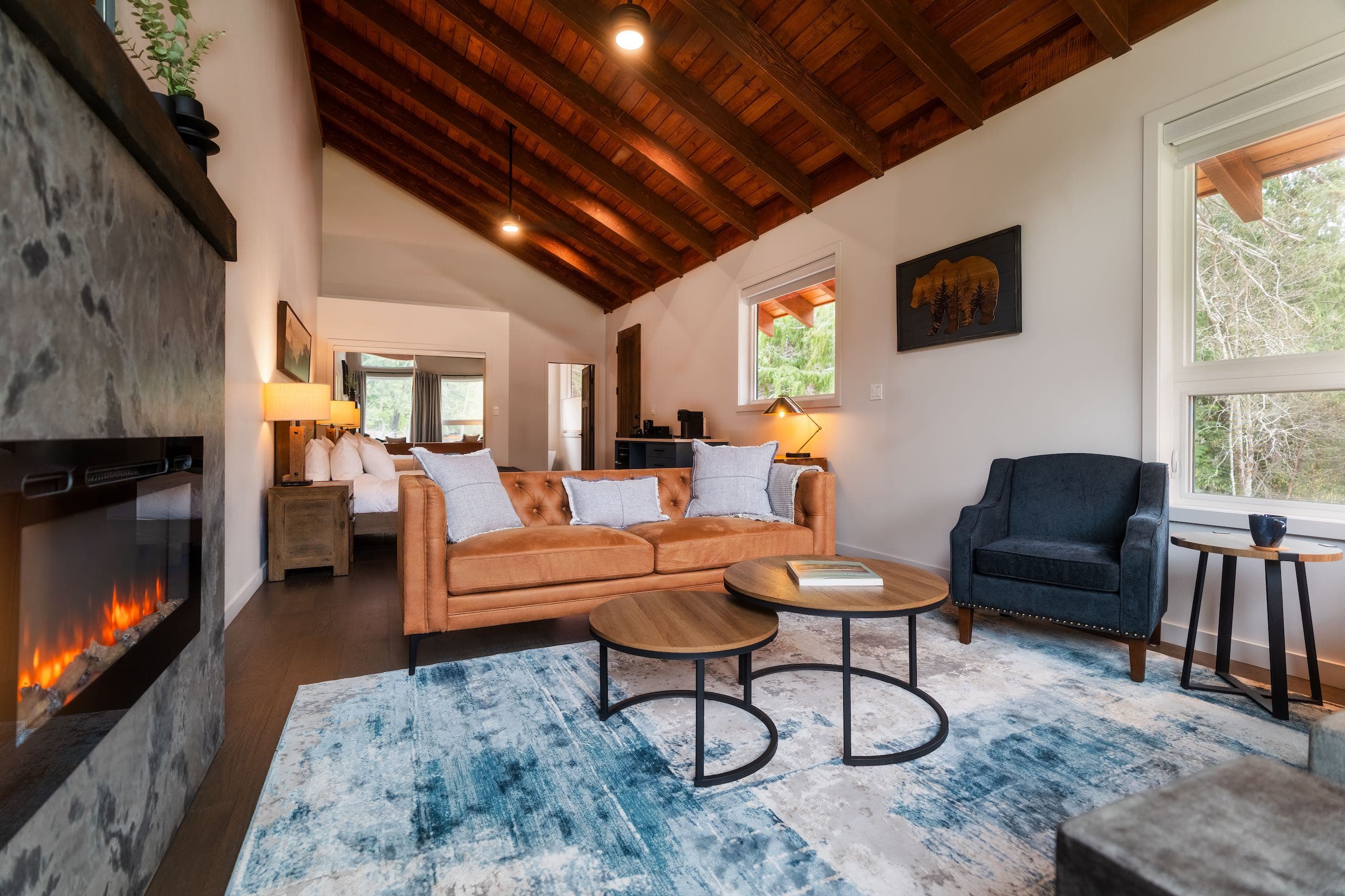 Seating area with a yellow couch and blue rug