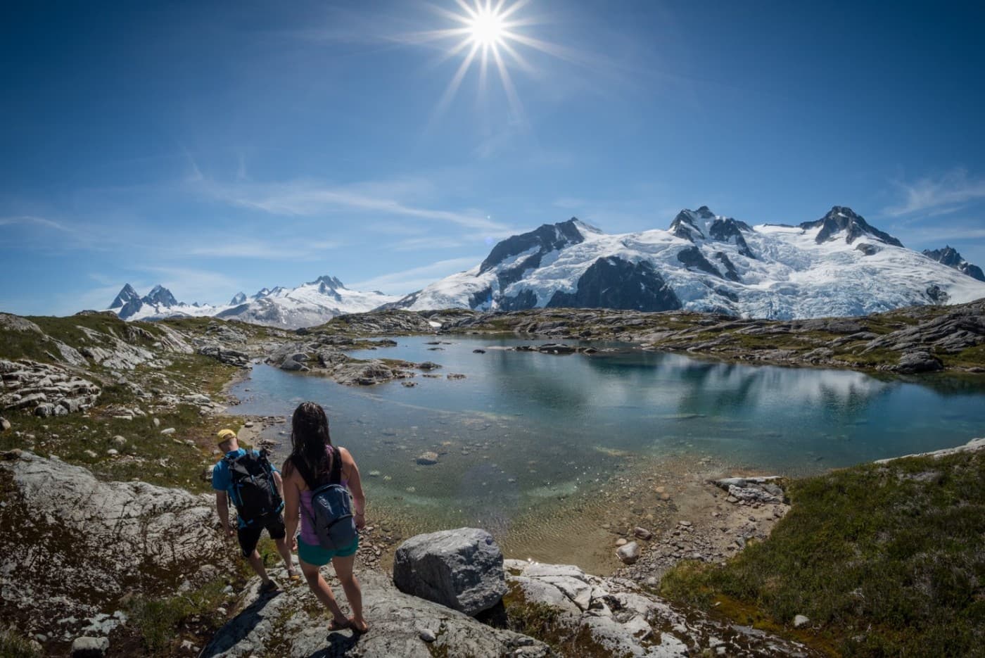 A group of people walking by glacial waters