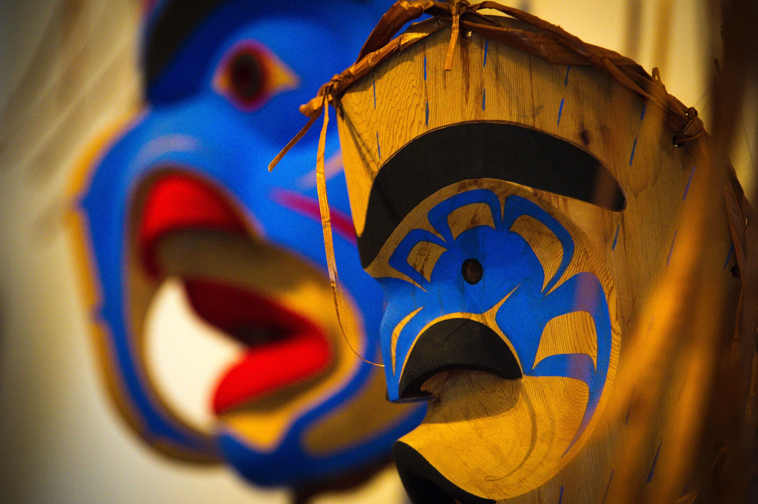 Carved and painted masks hanging on a wall