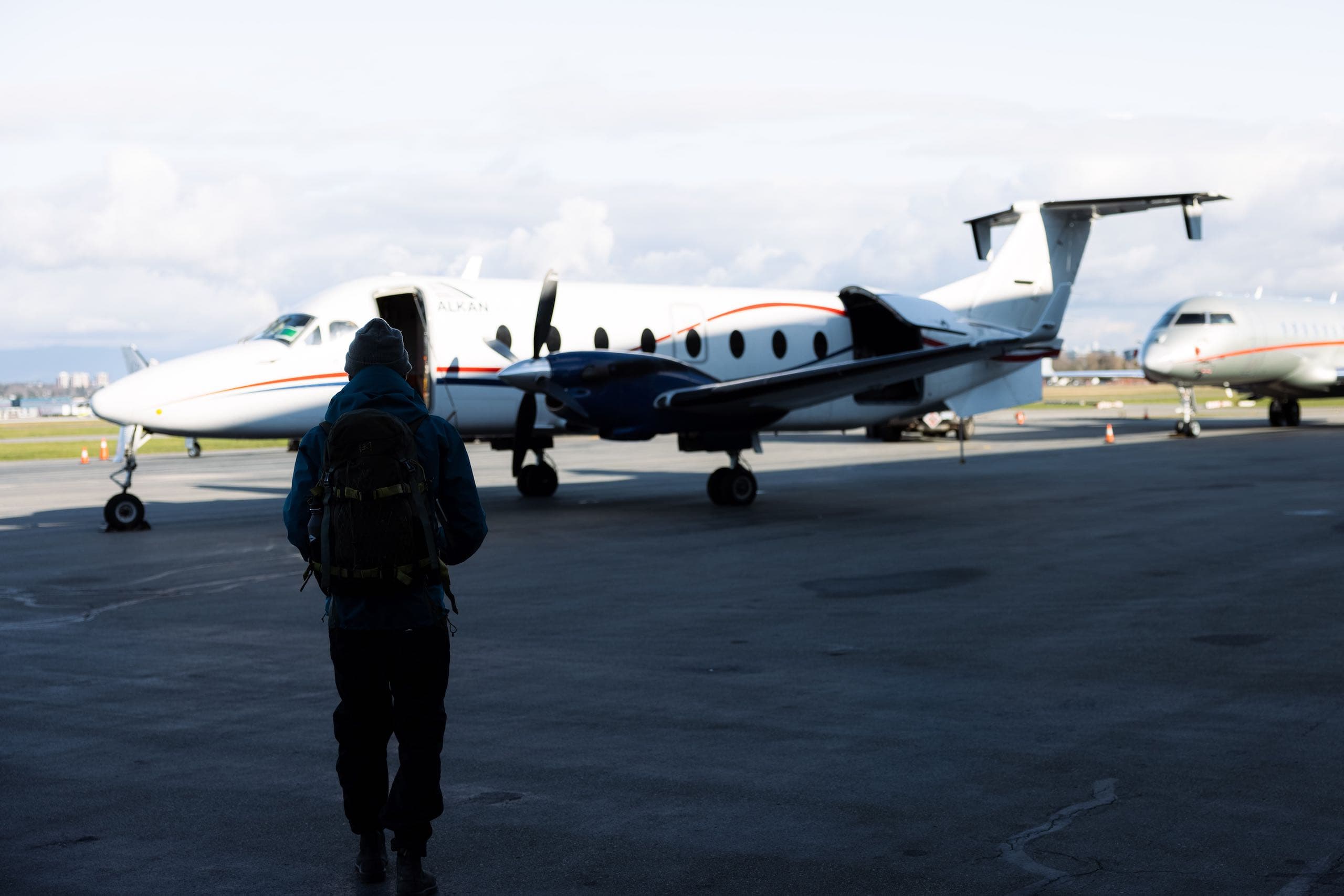 A man walking towards a plane